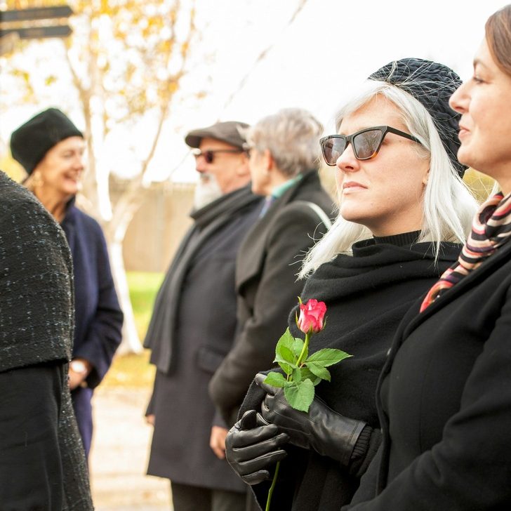Woman holding a rose in black garments at a funeral service | What Is a Life Insurance Assignment and How Does It Work (2026) - Family Funeral Funding