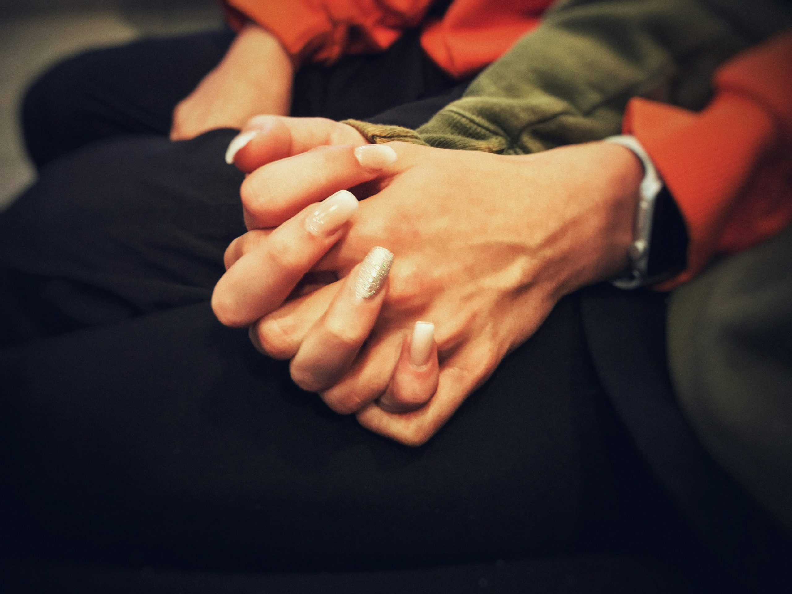 Couple sitting, holding hands, zoomed in on their hands interlocked | Advantages of Life Insurance Cash Advances | Family Funeral Funding - Helping Families with After Death Expenses | Bridging the gap between families, funeral homes and life insurance companies.